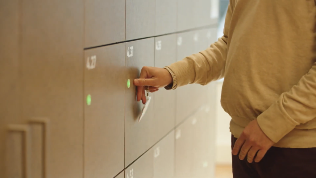 Office employees accessing smart lockers